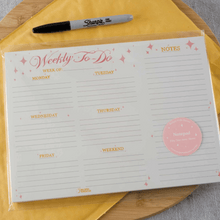 Load image into Gallery viewer, Weekly to do planner. Lined with pink heading and pink stars. Runs Monday to Friday with a section for the weekend.  Write your daily to-do's and weekly notes on one page.